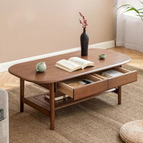 Modern wooden coffee table with open drawers, books, and vases.