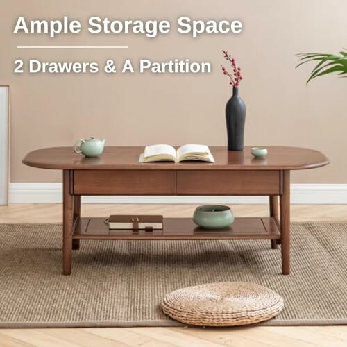 Wooden coffee table with two drawers and a partition, featuring decorative items.
